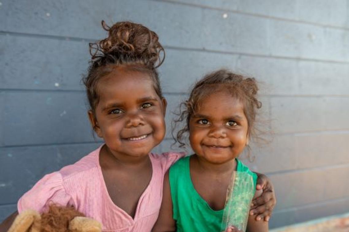 Two young Indigenous Australian girls smiling