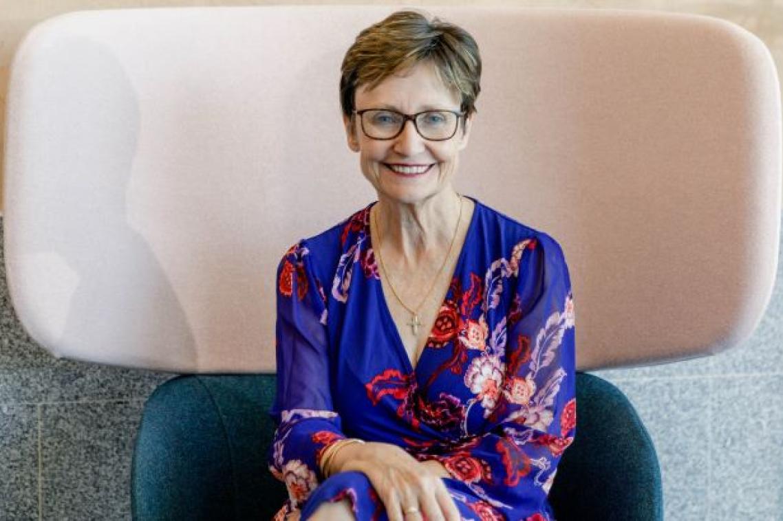 Associate Professor Rhonda Faragher seated in high back chair. Image, UQ