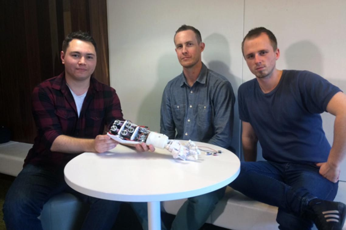 UQ Robotics Club members Fabian Vasuain and Lex Van Cooten with amputee consultant Ben Tarbuck (centre).