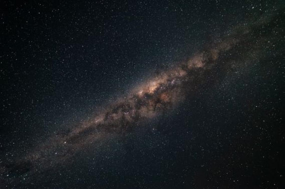 A photograph of the night sky with the Milky Way galaxy stretching out.
