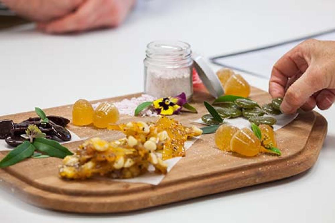An example of native food confectionery creations from past UQ students, including medicinal lozenges flavoured with lemon myrtle, a bunya and boppal brittle, a quandong and burdekin plum sherbet, desert lime jubes and sour lollies from Davidson plums.