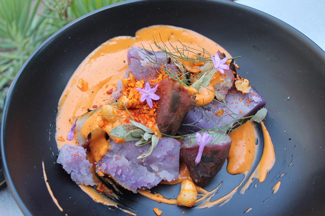 Close up of a plate containing Indigenous food coloured orange and purple