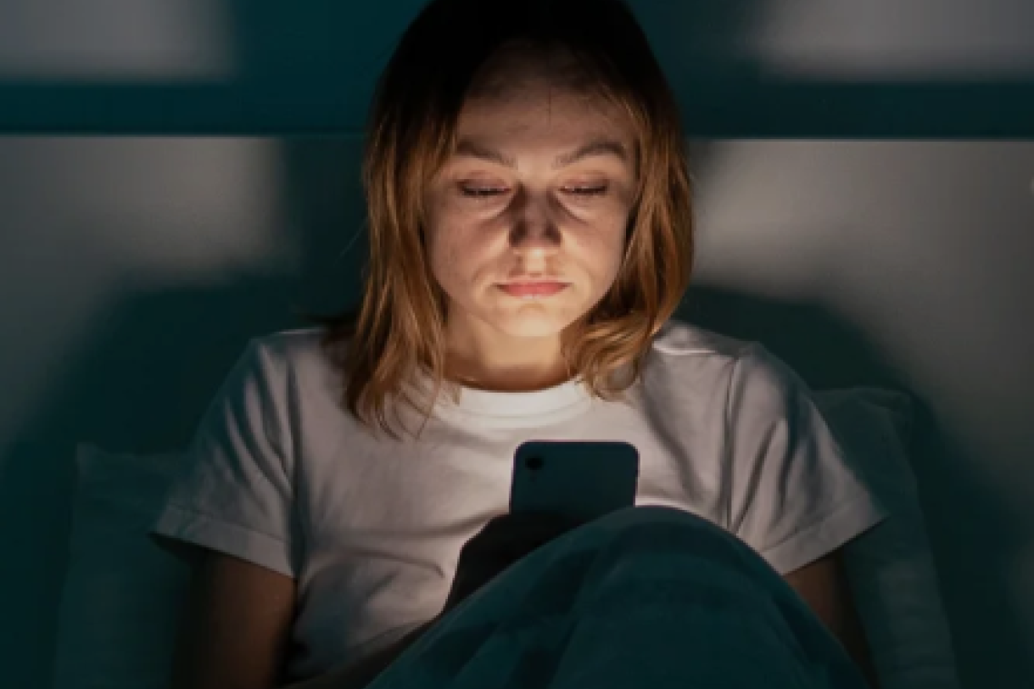 Person on the phone in bed