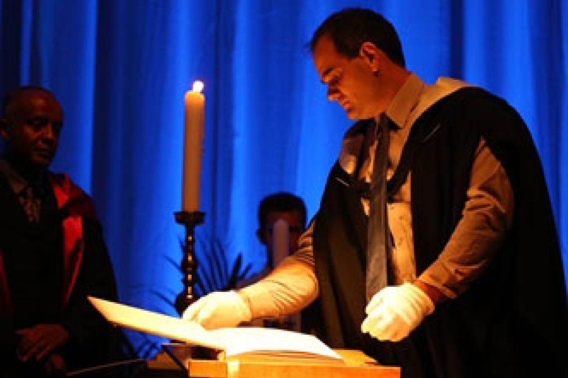 Photograph: Reading names from the Book of Remembrance at the 2014 UQ Thanksgiving Ceremony.