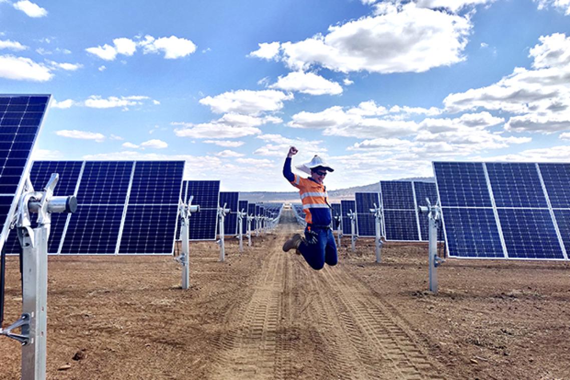 A worker jumps for joy at the Warwick Solar Farm project,