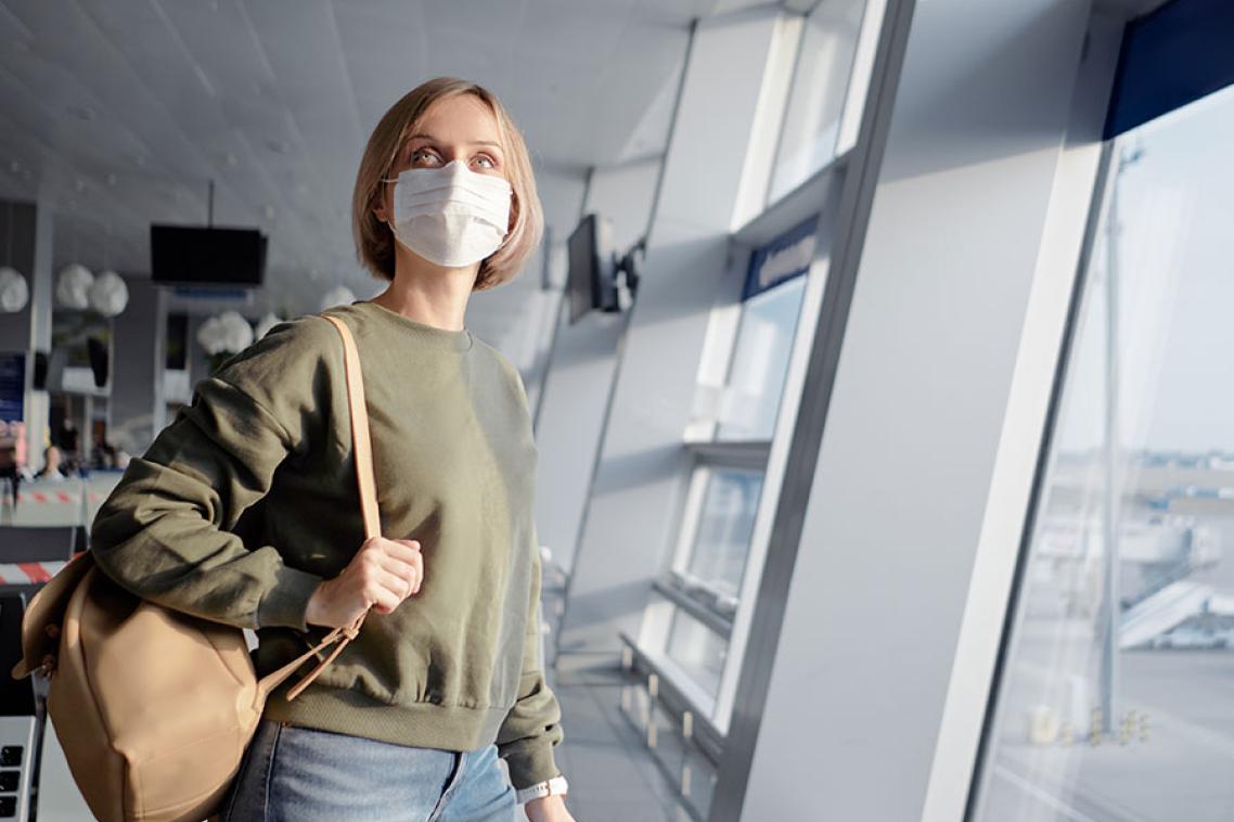 A woman with a mask on at an airport