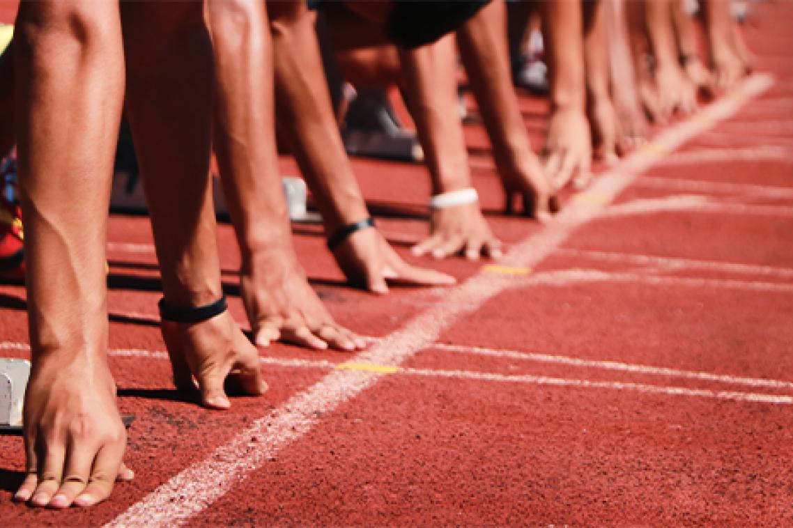 Generic image of a sprinters getting ready to start a race on an athletics track.