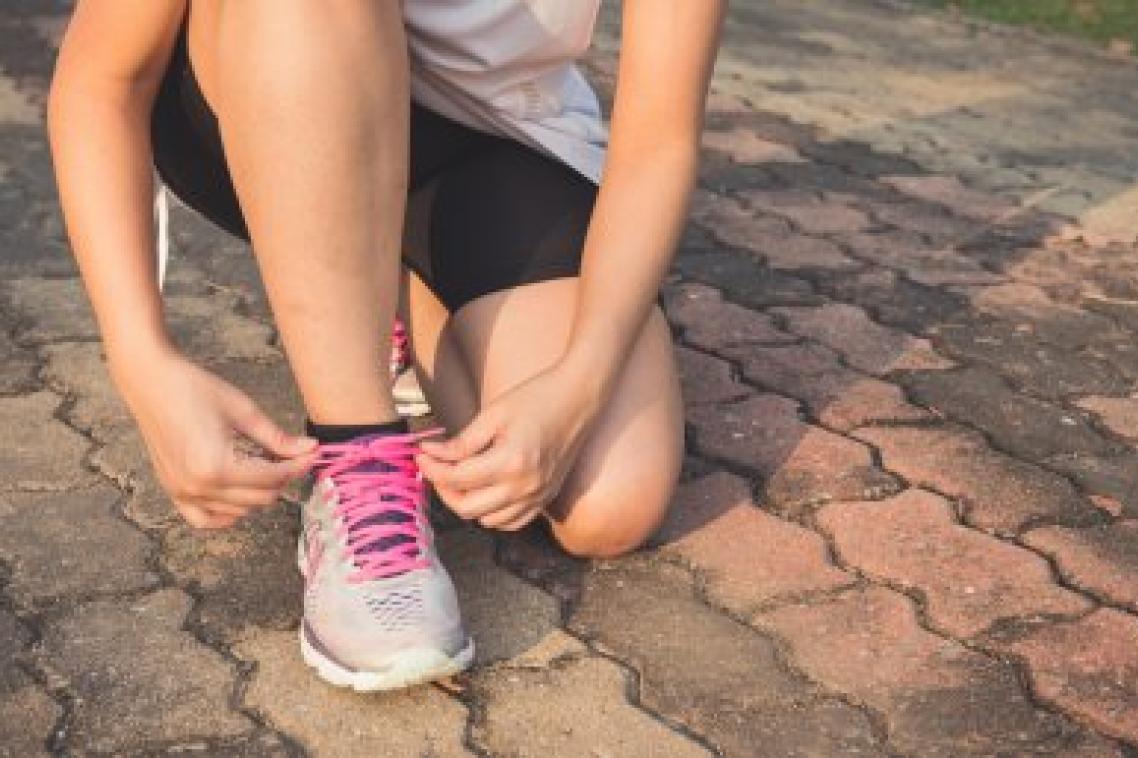 Person tying shoes before exercise
