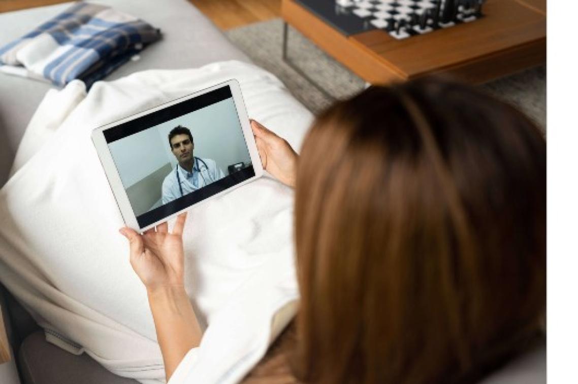 Woman staring at screen with doctor on it