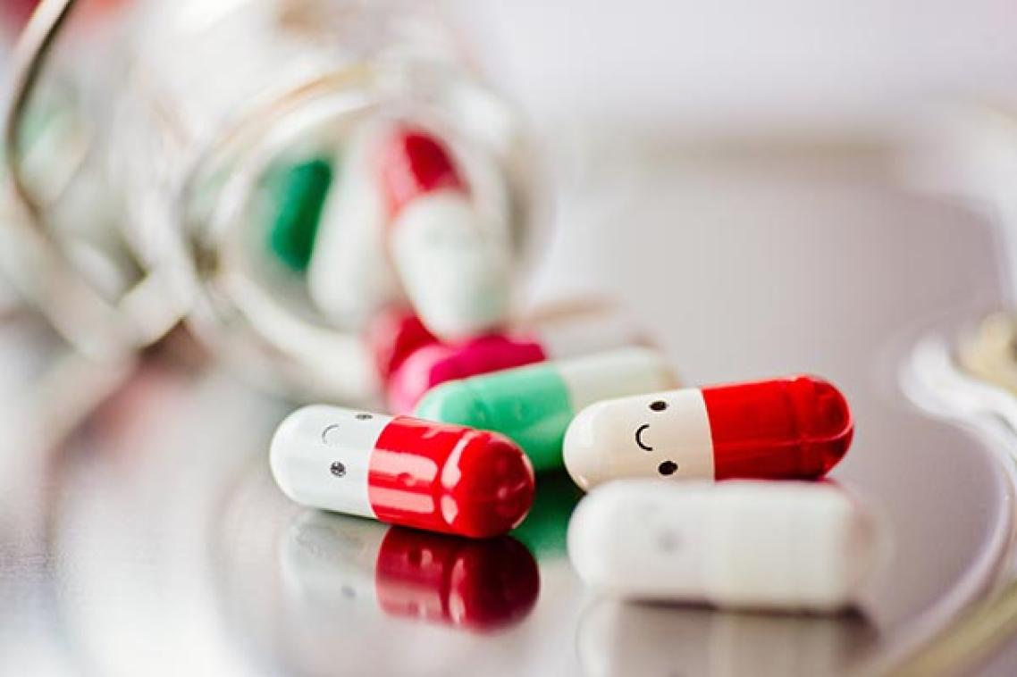 picture of pills in capsule form with happy faces drawn on them