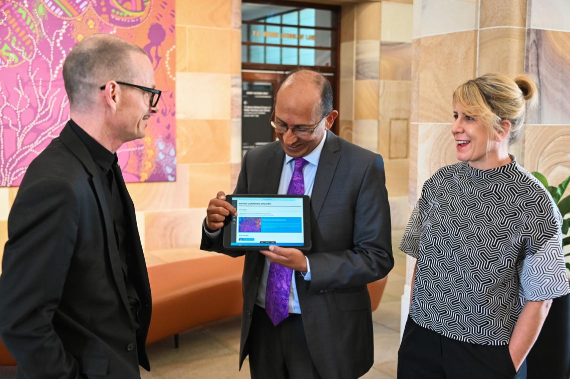 UQ Chancellor Peter Varghese shows staff early adopters, Professor Greg Hainge (left) and Sybilla Wilson (right) the Core Cultural Learning website.