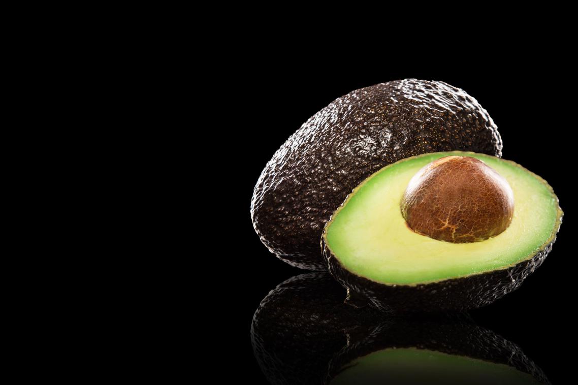 Avocado on black background.