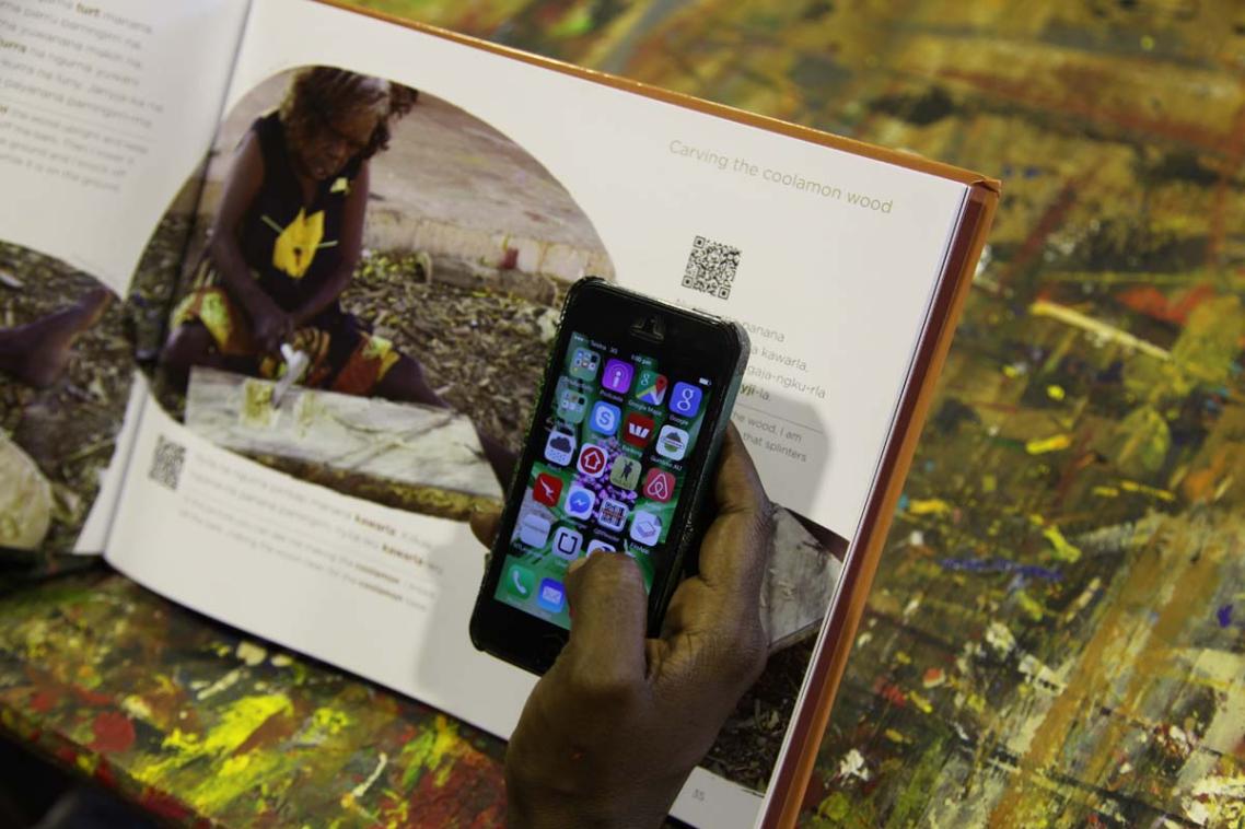 Cassandra Algy demonstrates using QR codes to hear audio of the Gurindji text in the Kawarla book.