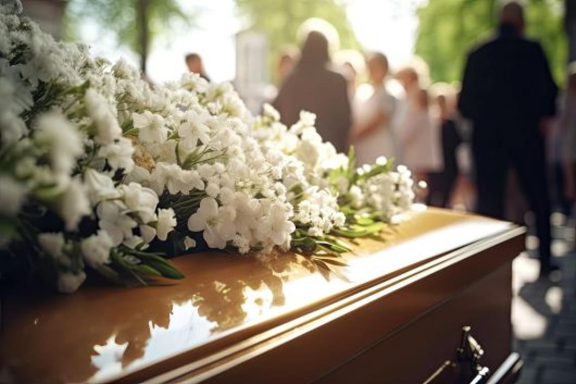 Flowers on top of a coffin at a funeral