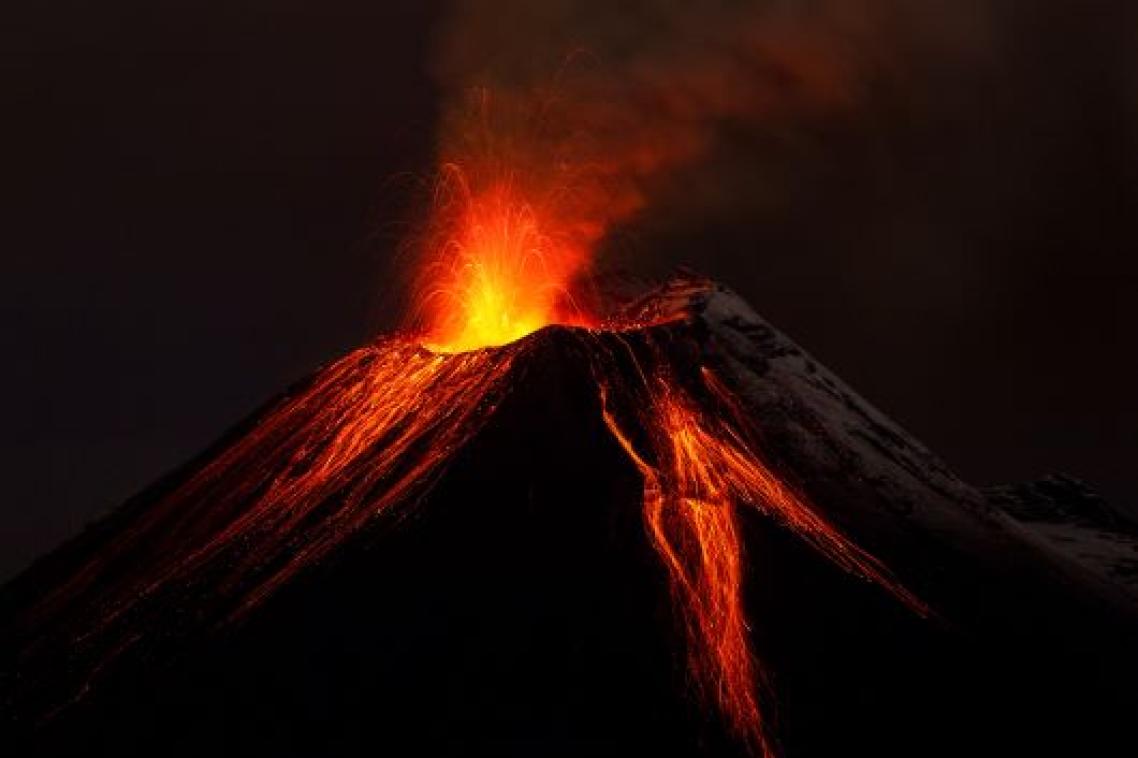 An erupting volcano at night. 