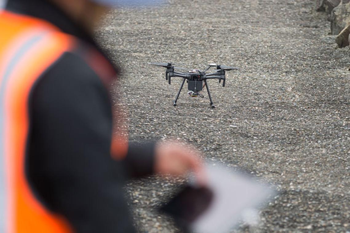 An operator prepares to launch a drone.