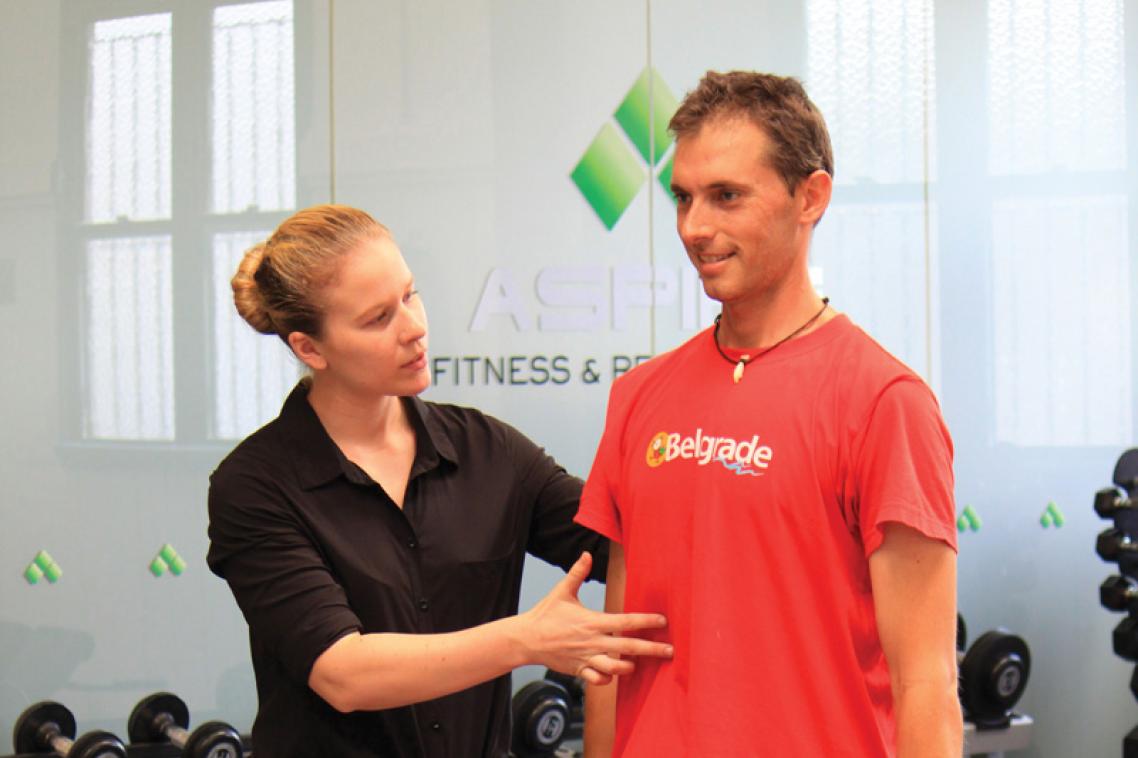 Molly Shevill helps a participant with the exercise program