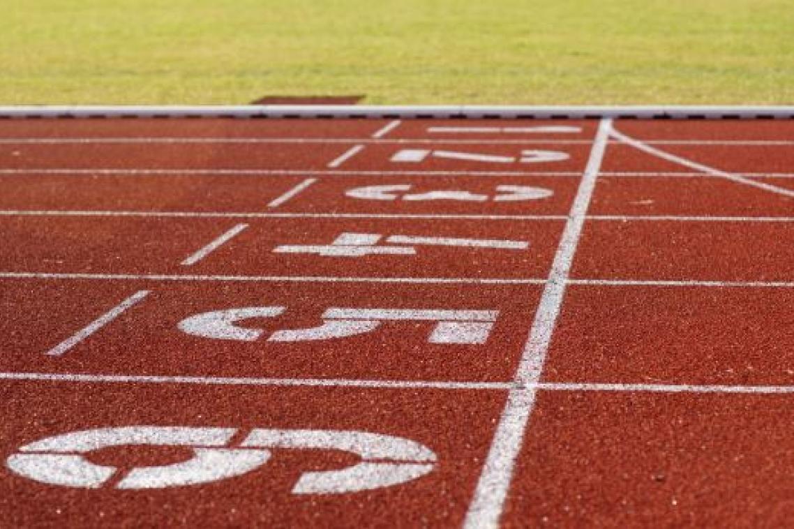 Red running track with white lines and number painted on.