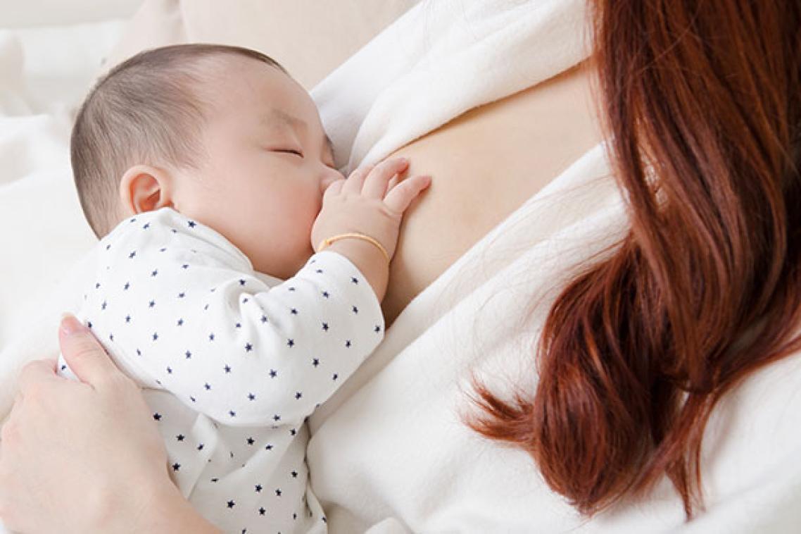A mother breastfeeding a baby