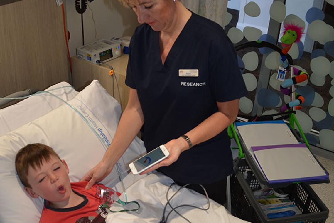 A doctor taking a child patient's temperature