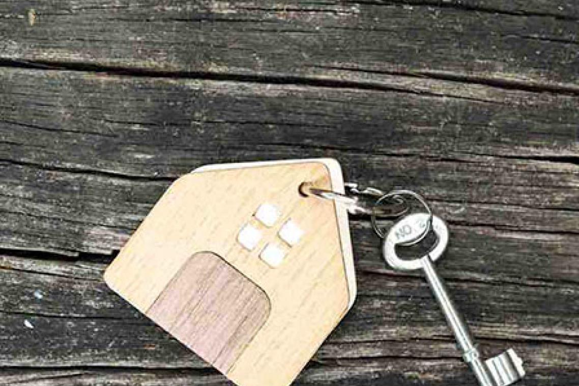 A key and small wooden house keychain