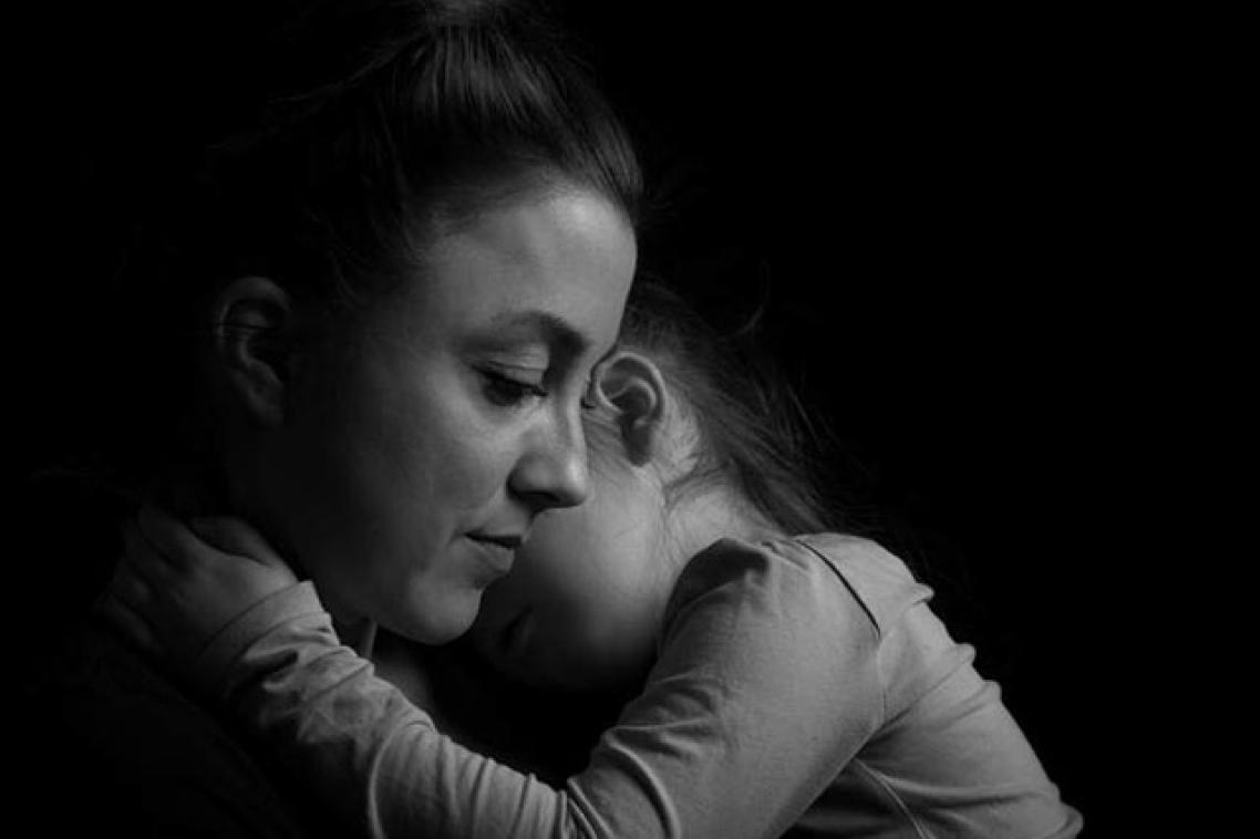 A solemn mother and her child in black and white
