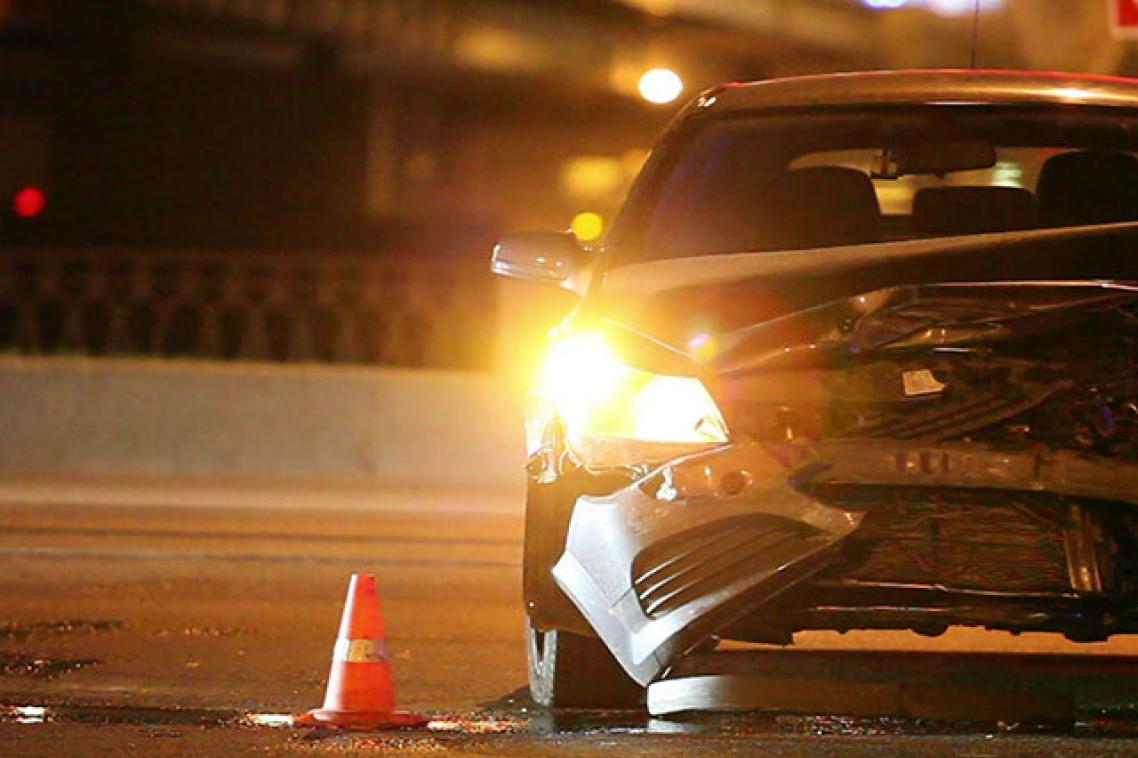 An impacted car with its hazard lights flashing