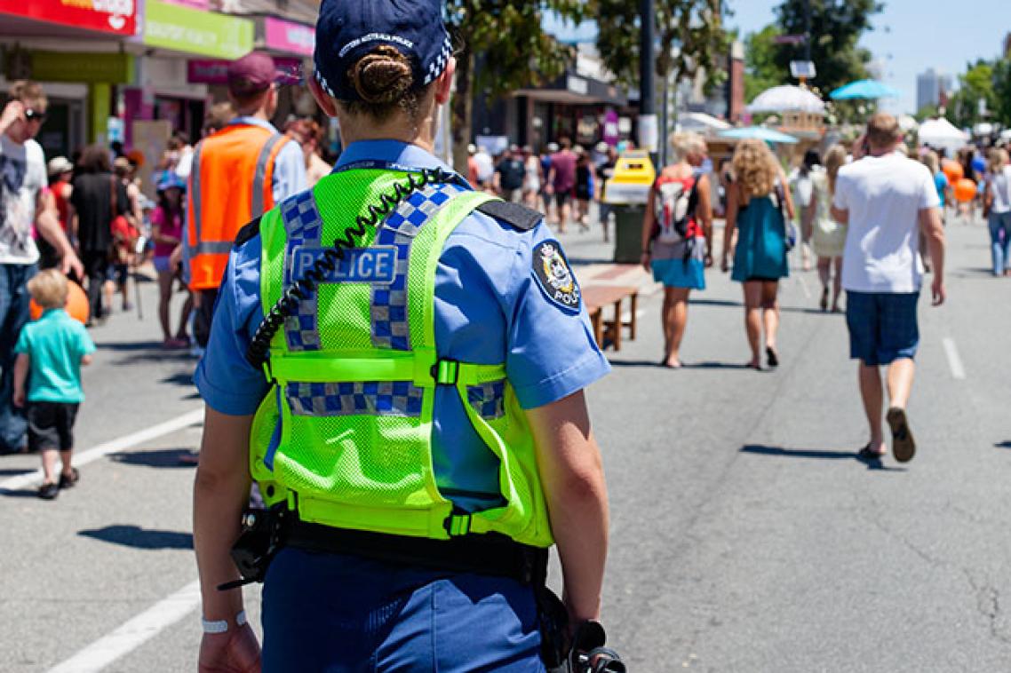 A police officer patrolling a busy street