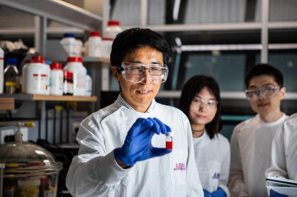 Team of UQ researchers in a lab