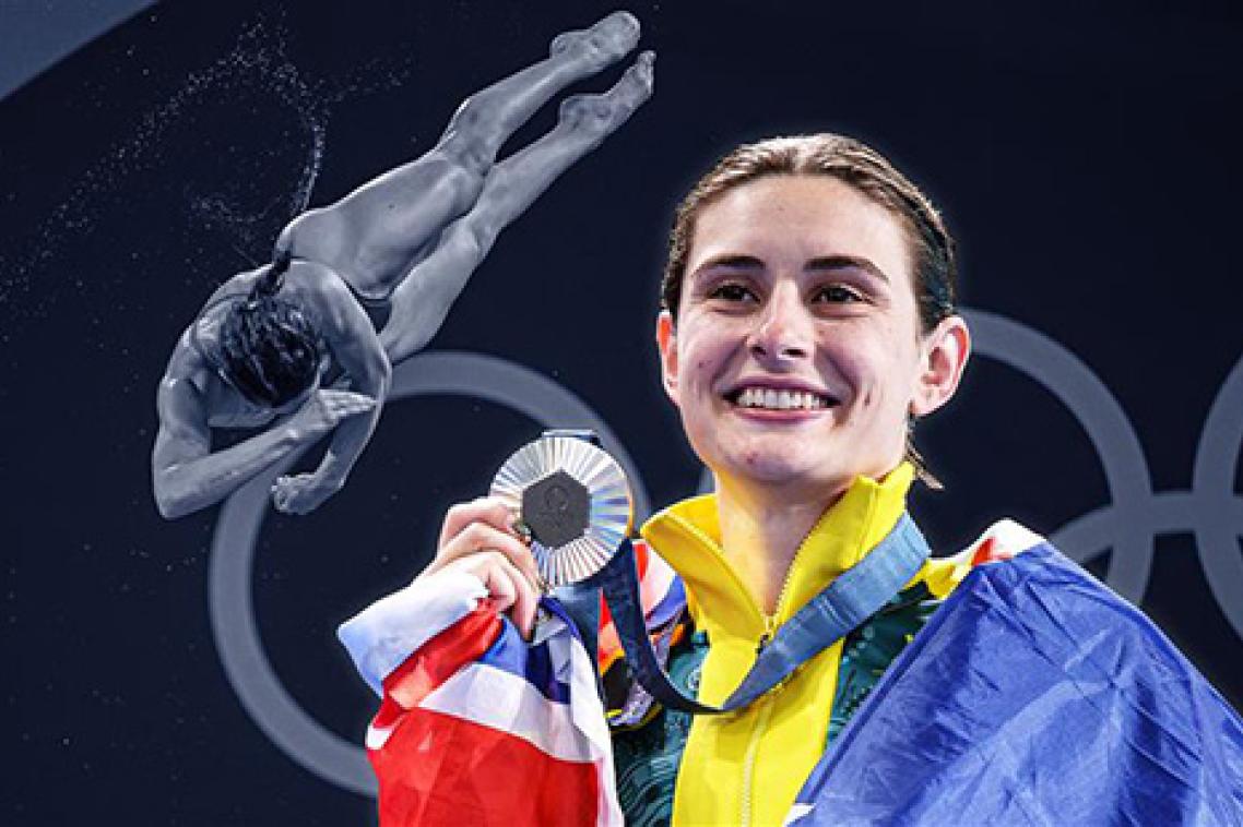 Maddison Keeney holding a silver Olympic medal and smiling with an Australian flag around her shoulders