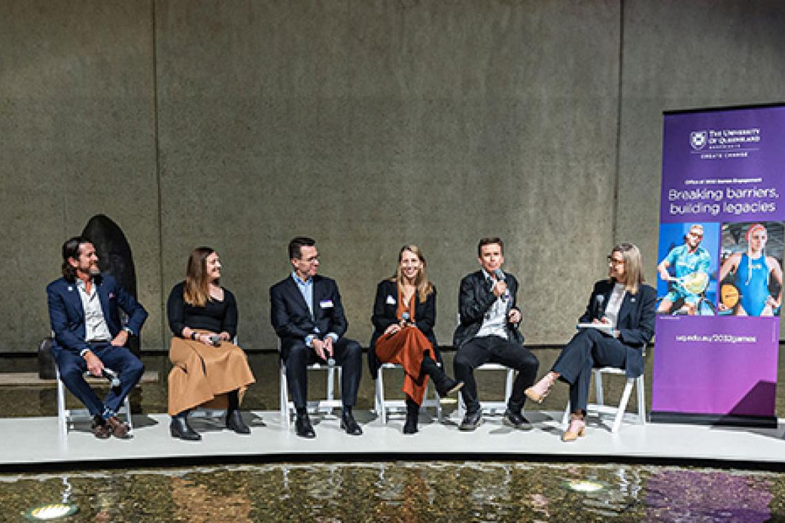 A panel of 6 people sitting at the front of a room