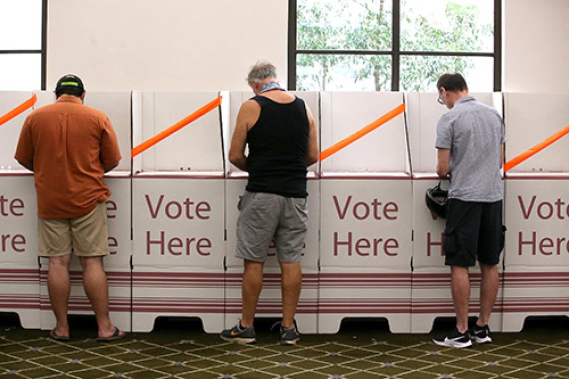 Men standing at Australian polling booths