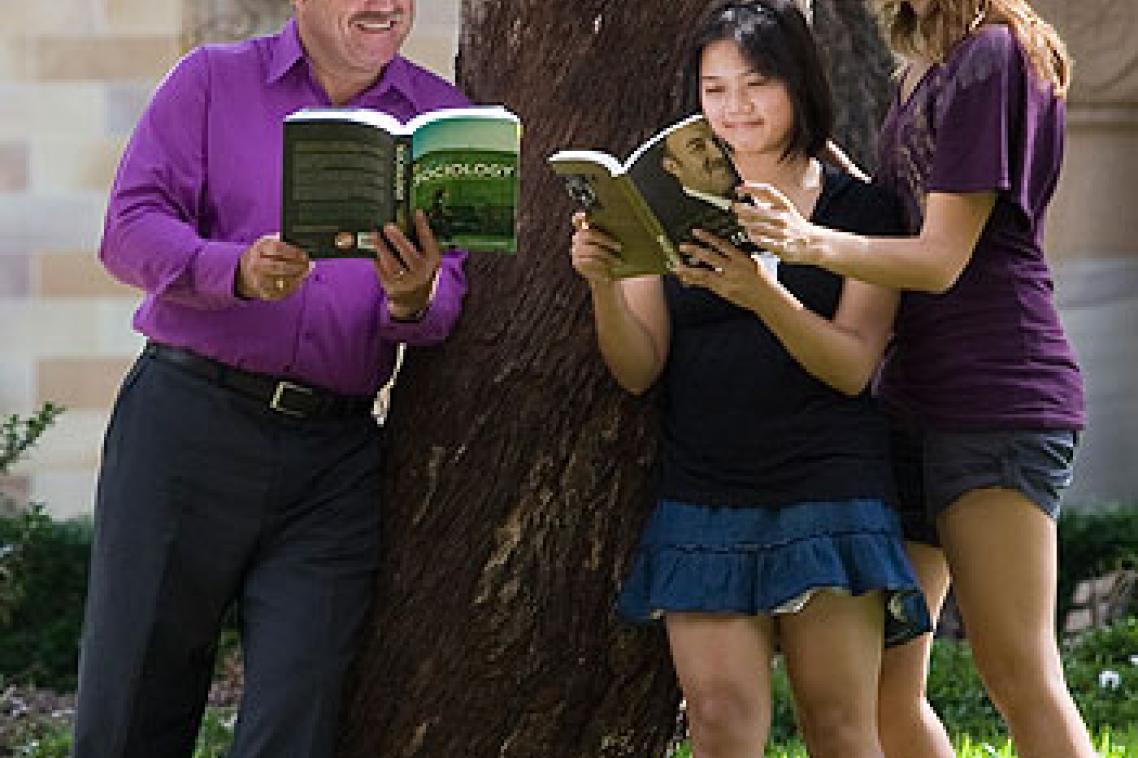 UQ students have a read of rugby league legend Wally Lewis's new autobiography at St Lucia